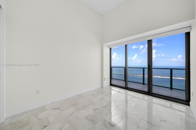 unfurnished room with a water view