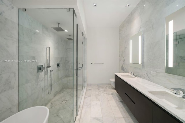 full bathroom with vanity, tile walls, shower with separate bathtub, and toilet