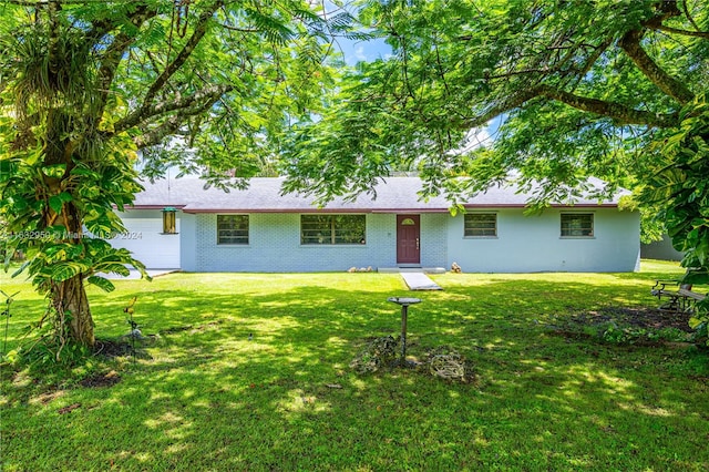 back of house featuring a garage and a yard