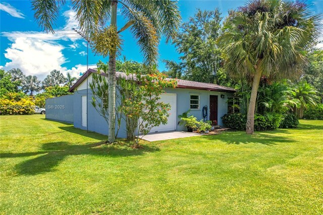 back of house with a lawn