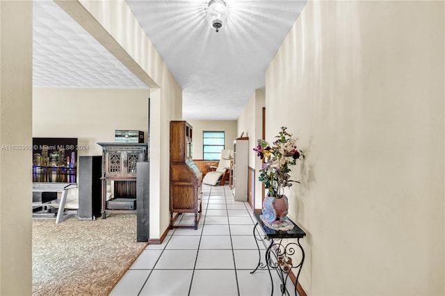 corridor featuring light tile patterned floors