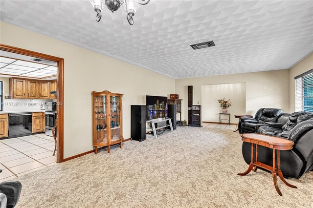 living room with light carpet and a textured ceiling