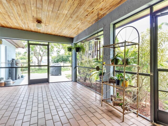 unfurnished sunroom with wood ceiling