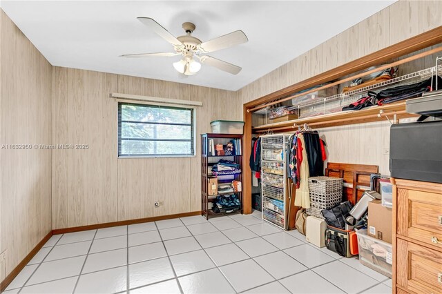 spacious closet with light tile patterned floors and ceiling fan