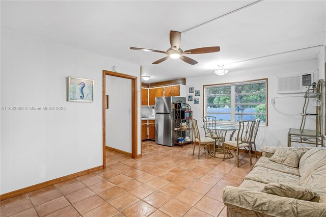 tiled living room featuring ceiling fan and a wall unit AC