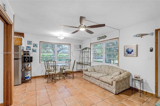 living room featuring ceiling fan, a healthy amount of sunlight, an AC wall unit, and light tile patterned floors