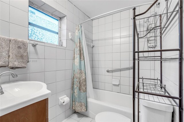 full bathroom with tile walls, vanity, toilet, shower / bath combo, and tile patterned floors