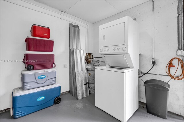 clothes washing area with stacked washer and dryer