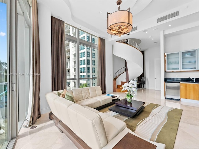 living room with sink and a wall of windows