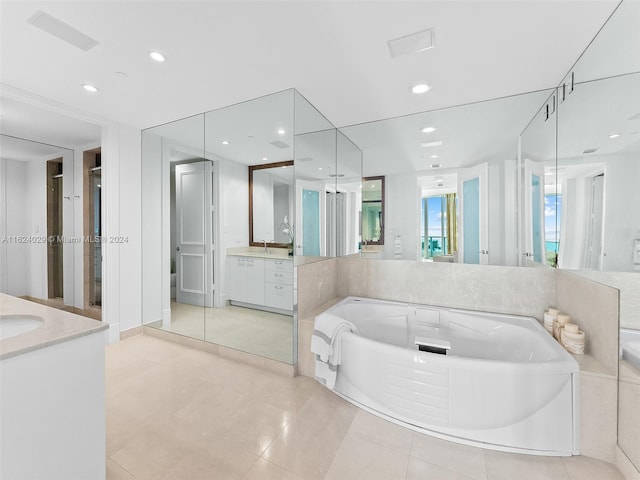 bathroom featuring tile patterned floors, a bathtub, and vanity