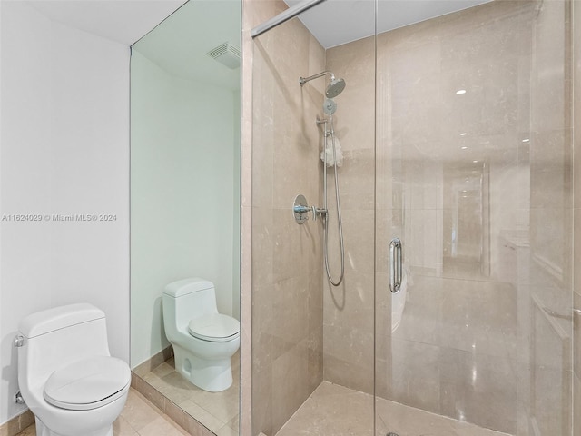 bathroom featuring walk in shower, tile patterned flooring, and toilet