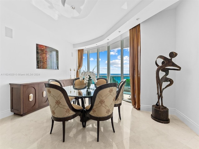 dining room featuring expansive windows and a water view