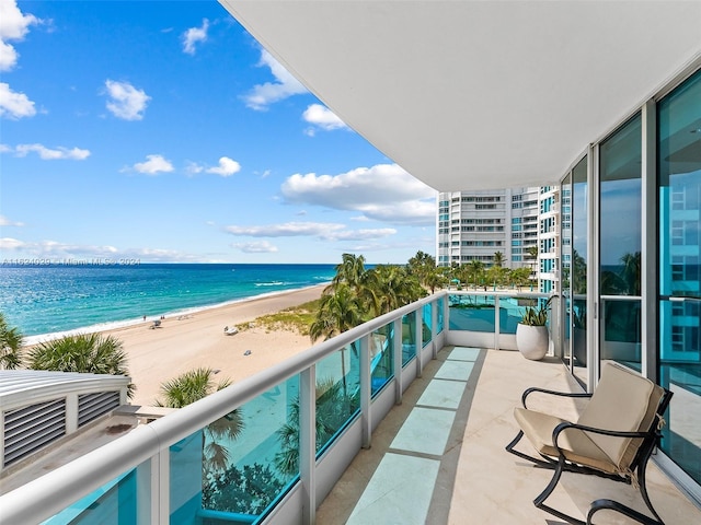 balcony with a water view and a beach view