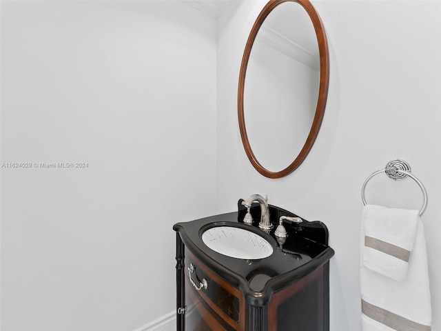 bathroom featuring vanity and ornamental molding