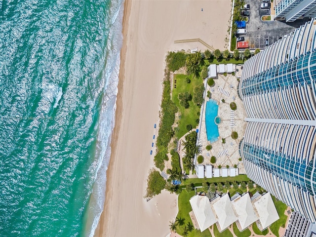 birds eye view of property featuring a water view and a beach view