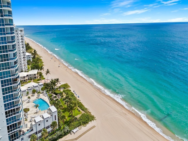 aerial view with a water view and a beach view