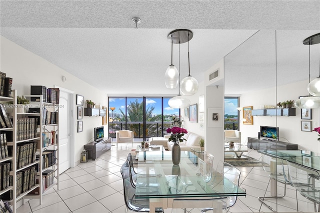 tiled dining area featuring expansive windows and a textured ceiling