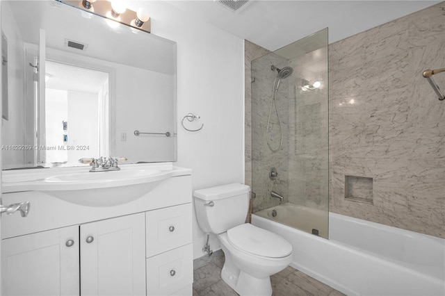 full bathroom featuring vanity, tile patterned flooring, tiled shower / bath combo, and toilet