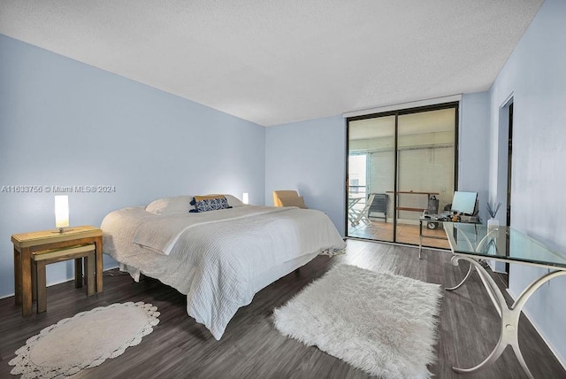 bedroom featuring floor to ceiling windows, dark hardwood / wood-style floors, a textured ceiling, and access to outside