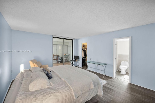 bedroom featuring ensuite bathroom, a spacious closet, a textured ceiling, a closet, and hardwood / wood-style flooring