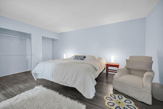 bedroom featuring dark hardwood / wood-style floors and a textured ceiling