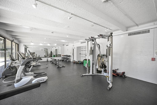 exercise room featuring a textured ceiling