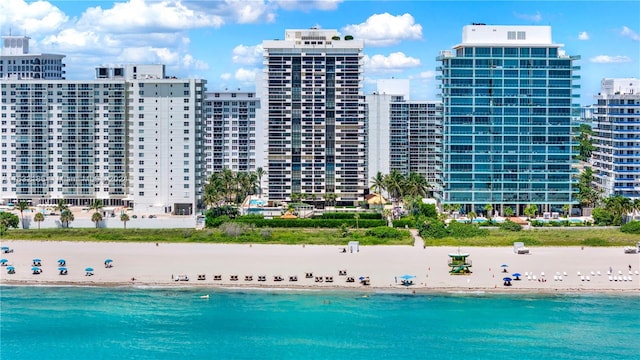 view of swimming pool featuring a view of the beach and a water view