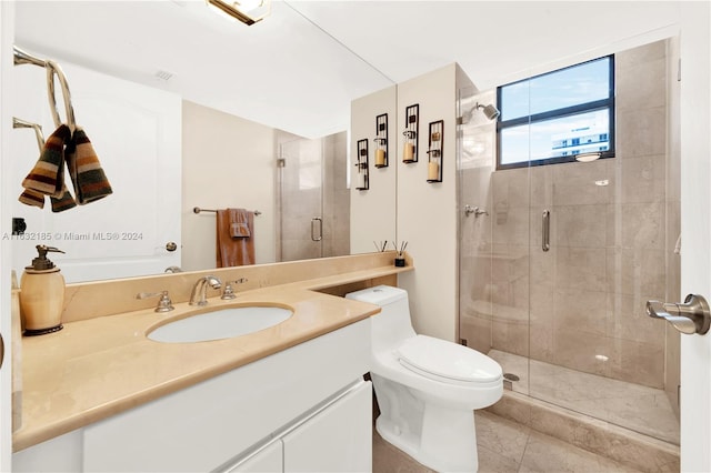 bathroom featuring a shower with shower door, vanity, and toilet