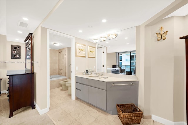 full bathroom featuring tile patterned flooring, tiled shower / bath combo, toilet, and vanity