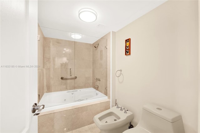 bathroom with a bidet, tile patterned flooring, tiled shower / bath, and toilet