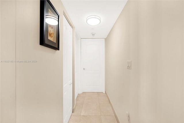 5757 Collins Ave Unit 801, Miami Beach, FL 33140 - hall featuring light tile patterned floors and baseboards