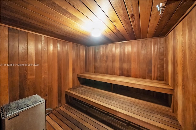 view of sauna / steam room featuring wood ceiling, wooden walls, and wood-type flooring