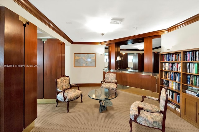 sitting room featuring crown molding and light colored carpet