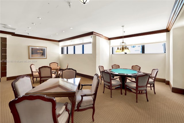 dining space featuring an inviting chandelier, crown molding, and carpet