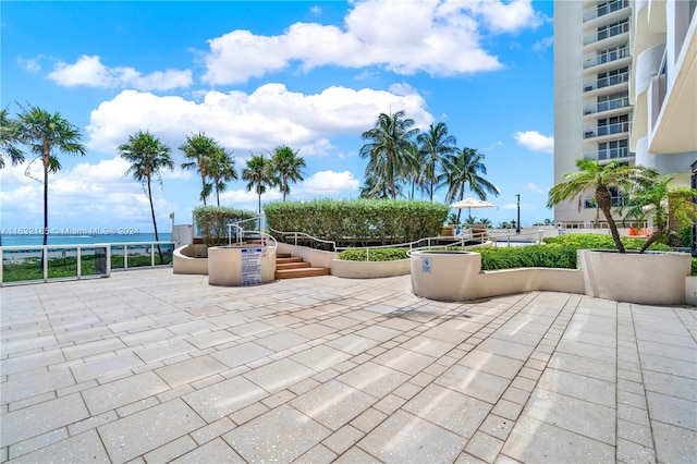 view of patio / terrace featuring a balcony and a water view