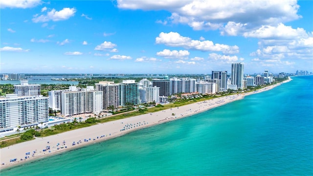 birds eye view of property featuring a water view and a view of the beach