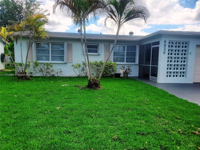 exterior space featuring a garage and a lawn