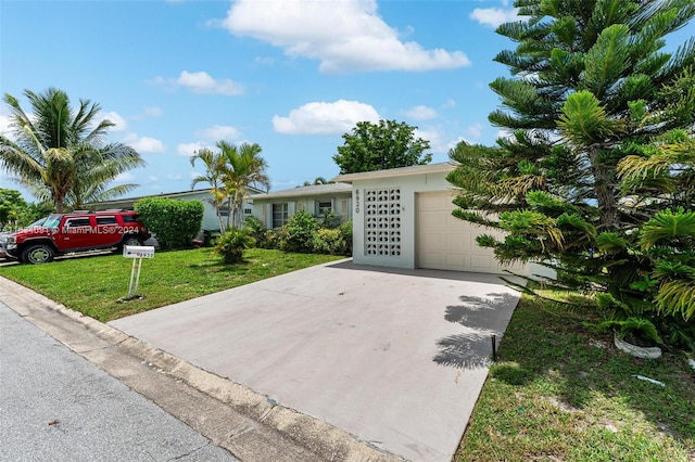 ranch-style house with a garage and a front lawn