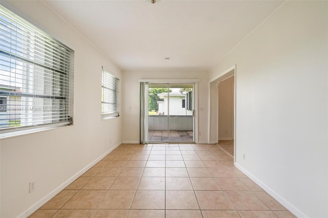 unfurnished room with light tile patterned floors