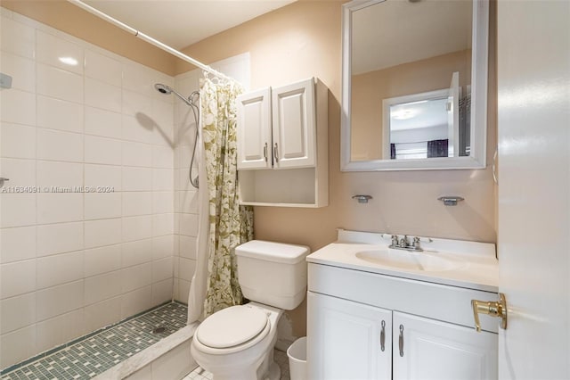 bathroom with vanity, a shower with shower curtain, and toilet