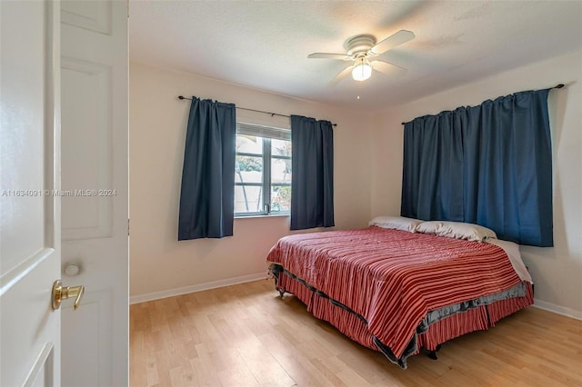 bedroom featuring light hardwood / wood-style flooring and ceiling fan