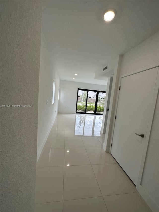 corridor featuring light tile patterned floors