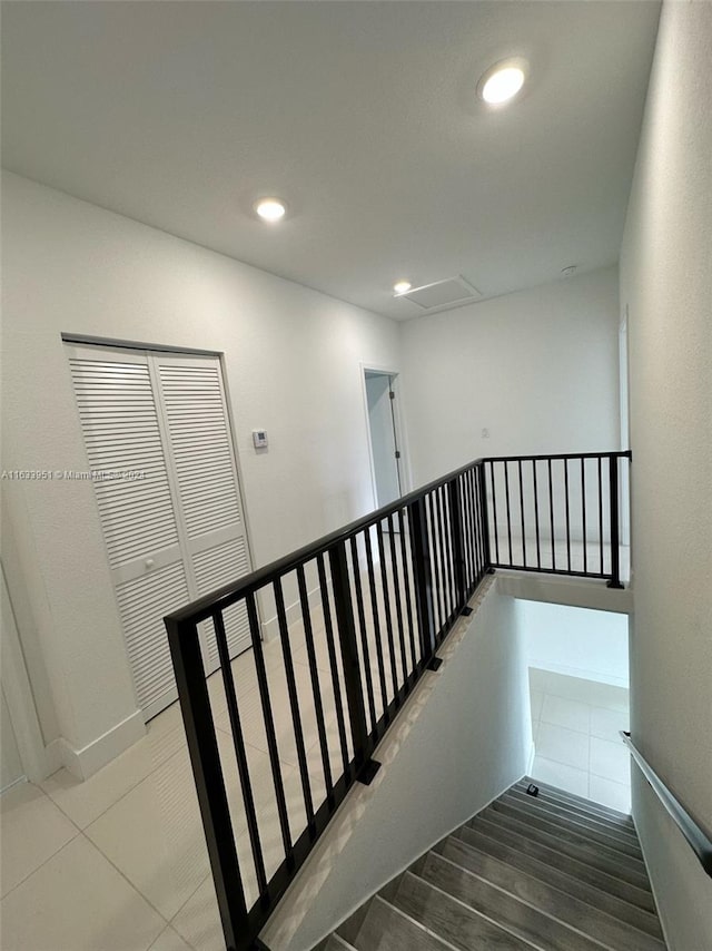 stairs featuring hardwood / wood-style floors