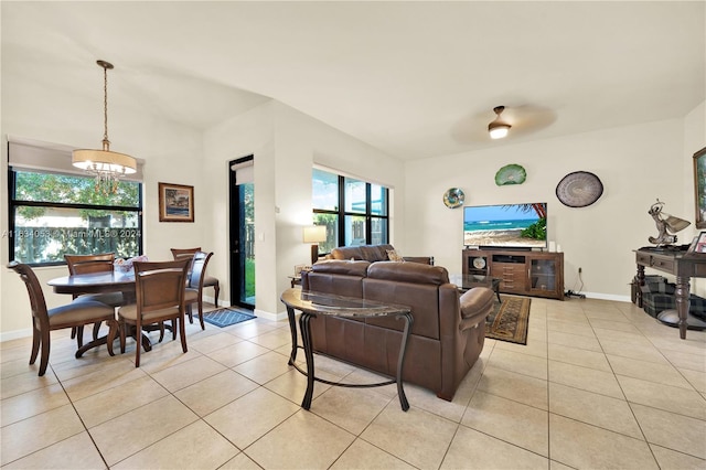 tiled living room featuring ceiling fan and a wealth of natural light