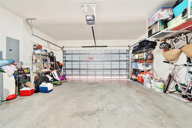 garage with electric panel and a garage door opener