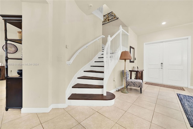 stairway with light tile patterned floors