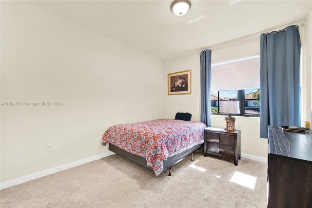 bedroom featuring light carpet