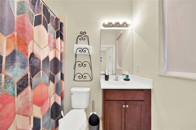 bathroom featuring toilet and vanity