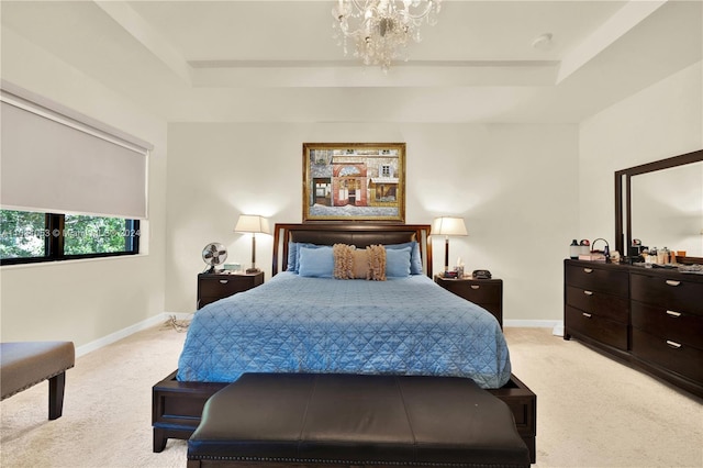 bedroom with light carpet, a chandelier, and a tray ceiling