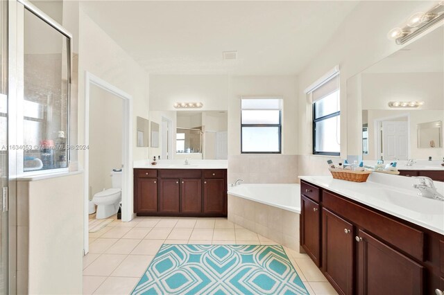 bathroom with a bidet, separate shower and tub, tile patterned flooring, and double sink vanity